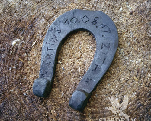 forging decorative horseshoe at wedding